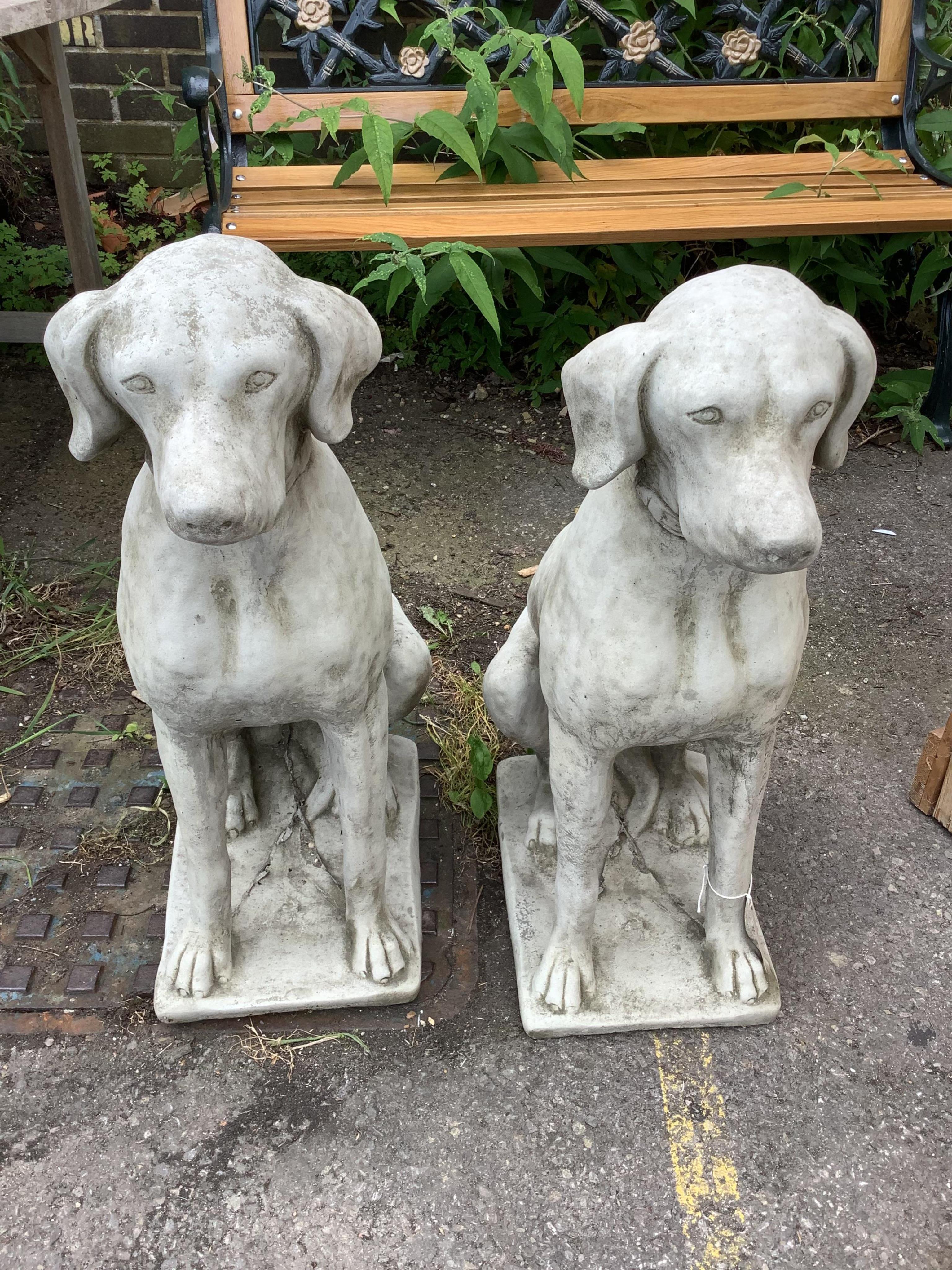 A pair of reconstituted stone seated hound garden ornaments, height 71cm. Condition - good